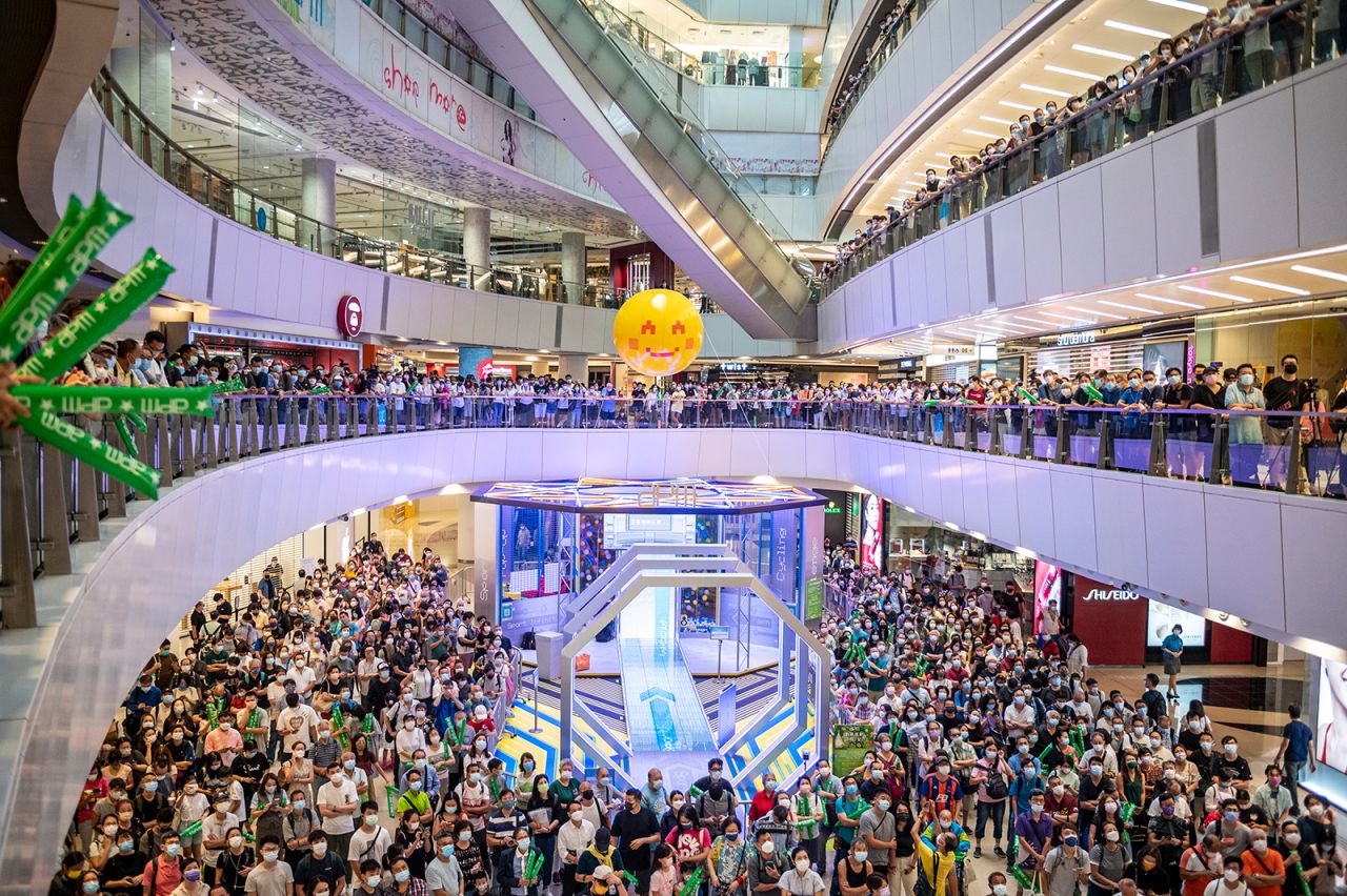 People react as they watch Siobhan Bernadette Haughey of Hong Kong swim in the women's 100-meter freestyle final at the 2020 Summer Olympics, at a shopping mall in Hong Kong, Friday, July 30.