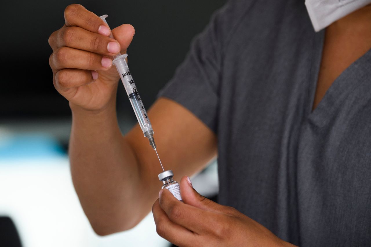 A physician assistant prepares a syringe with a dose of the Pfizer Covid-19 vaccine at a mobile vaccination clinic at the Weingart East Los Angeles YMCA on May 14, 2021 in Los Angeles, California. - The campaign to immunize America's 17 million adolescents aged 12-to-15 kicked off in full force on May 13. 