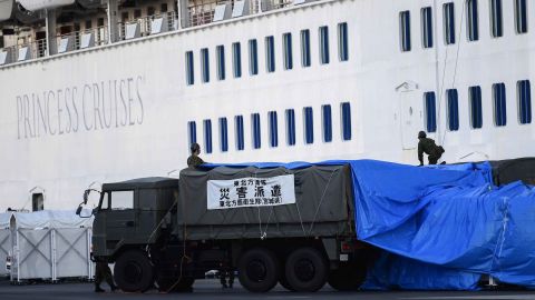 Japanese military personnel set up a covered walkway next to the Diamond Princess cruise ship on Monday in Yokohama, Japan.
