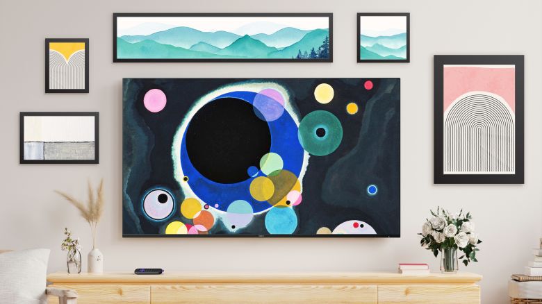 Roku Pro Series TV in art-based Backdrops mode on a wall