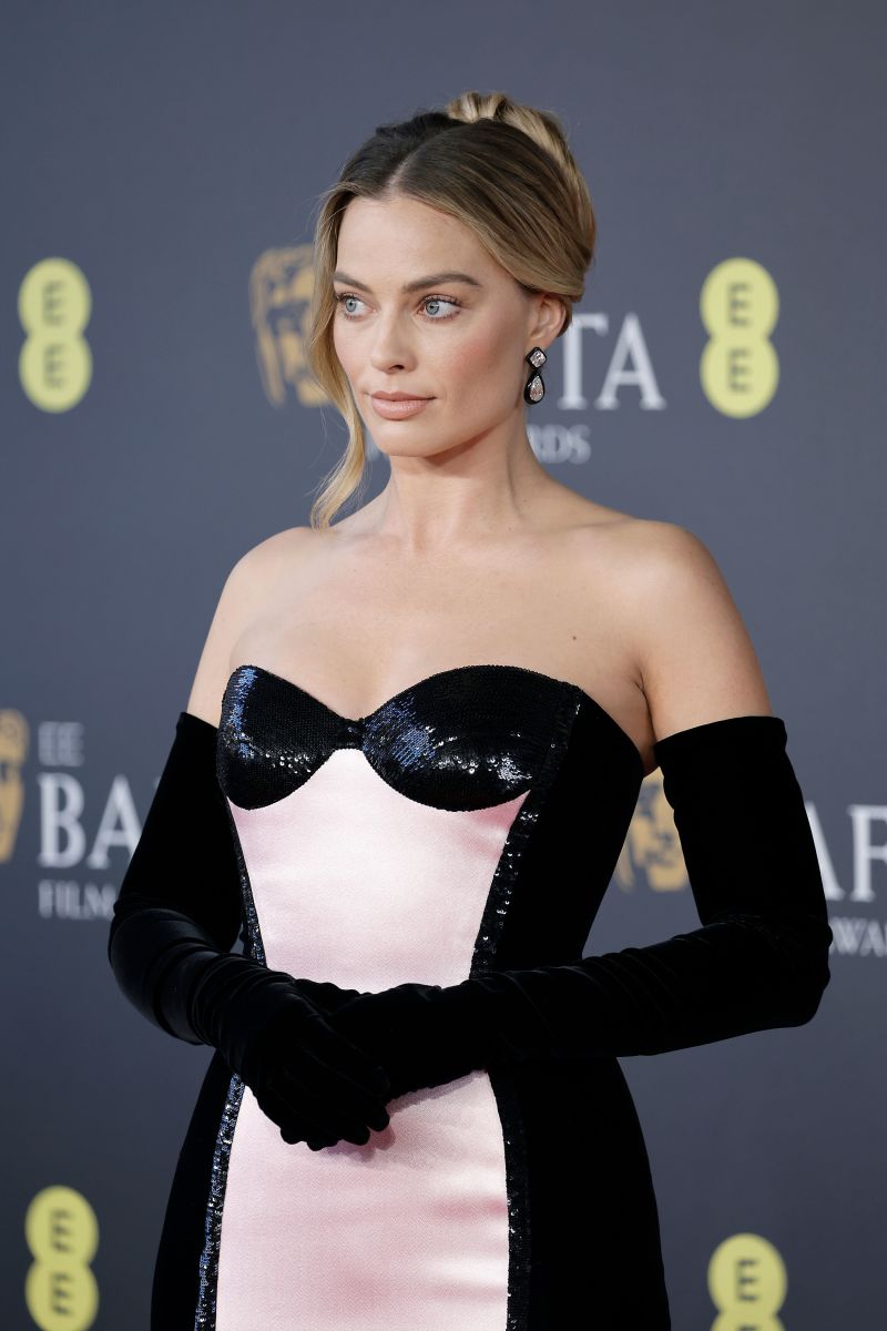 Margot Robbie in yet more Barbie pink — this time a custom gown by Giorgio Armani Privé.