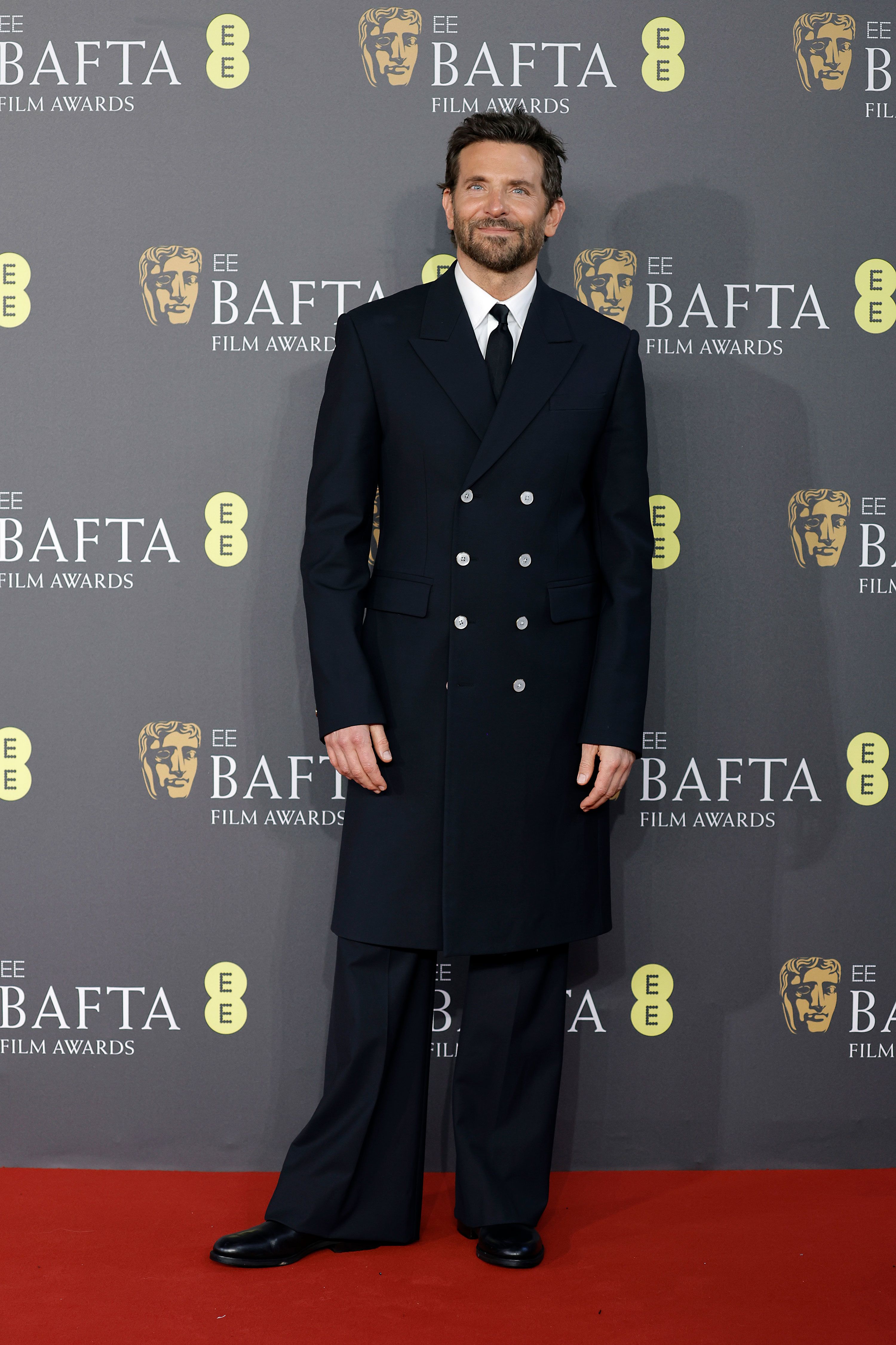 Bradley Cooper in a '70s-inspired long-line double-breasted jacket and flares by Louis Vuitton.