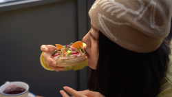 Woman eating bagel in china