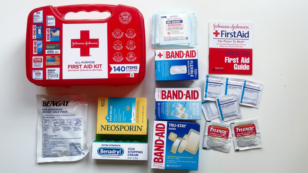 The Band-Aid Johnson and Johnson 140-piece first aid kit, with all contents laid out on a white tabletop