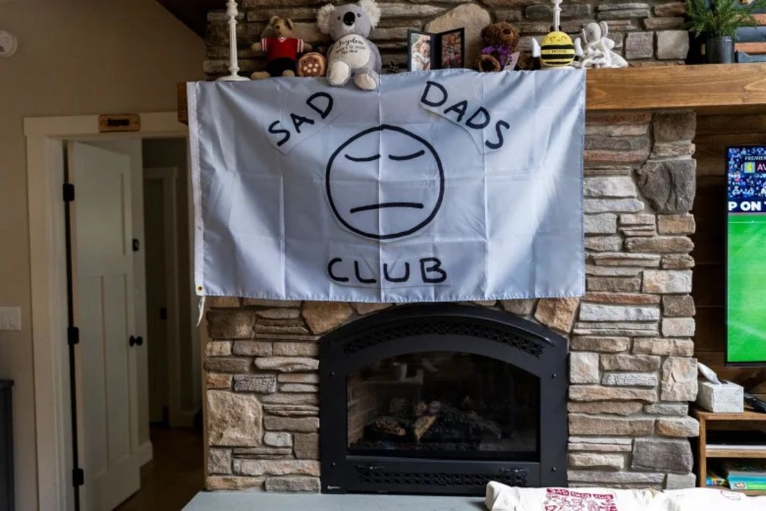 Los asistentes al retiro del Club de Padres Tristes ponen recuerdos de sus hijos fallecidos en la repisa de una chimenea en el retiro en Raymond, Maine.