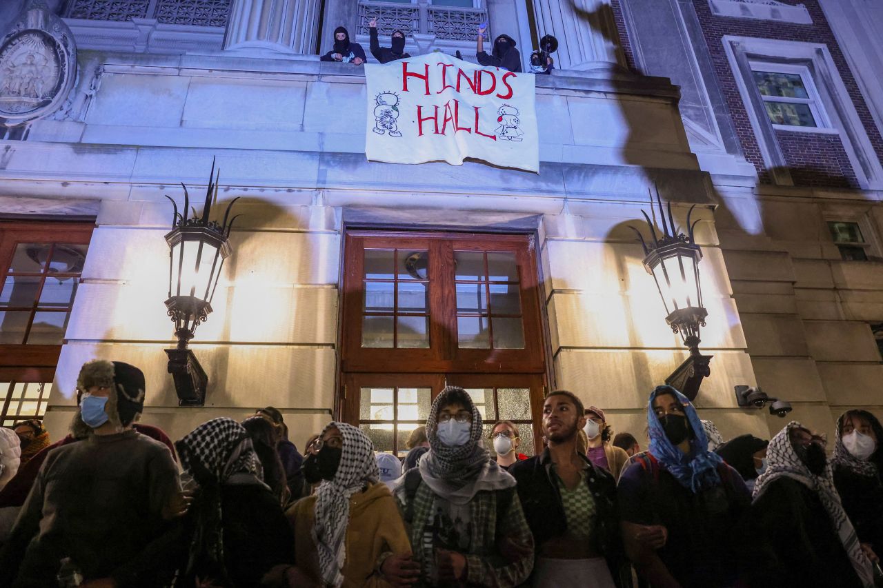 Protesters link arms outside Hamilton Hall, barricading students inside the building.