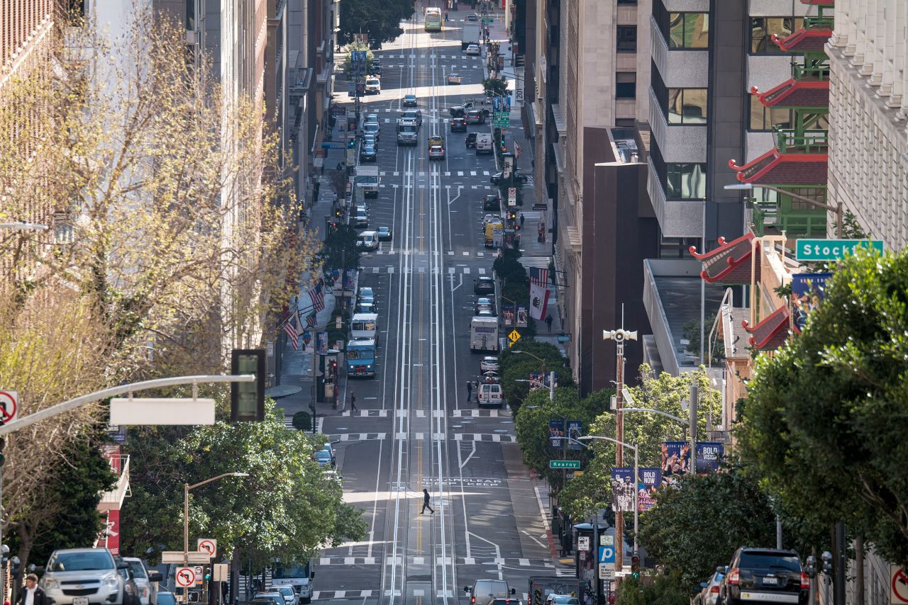 A pedestrian crosses an empty street in San Francisco on Tuesday, March 17.