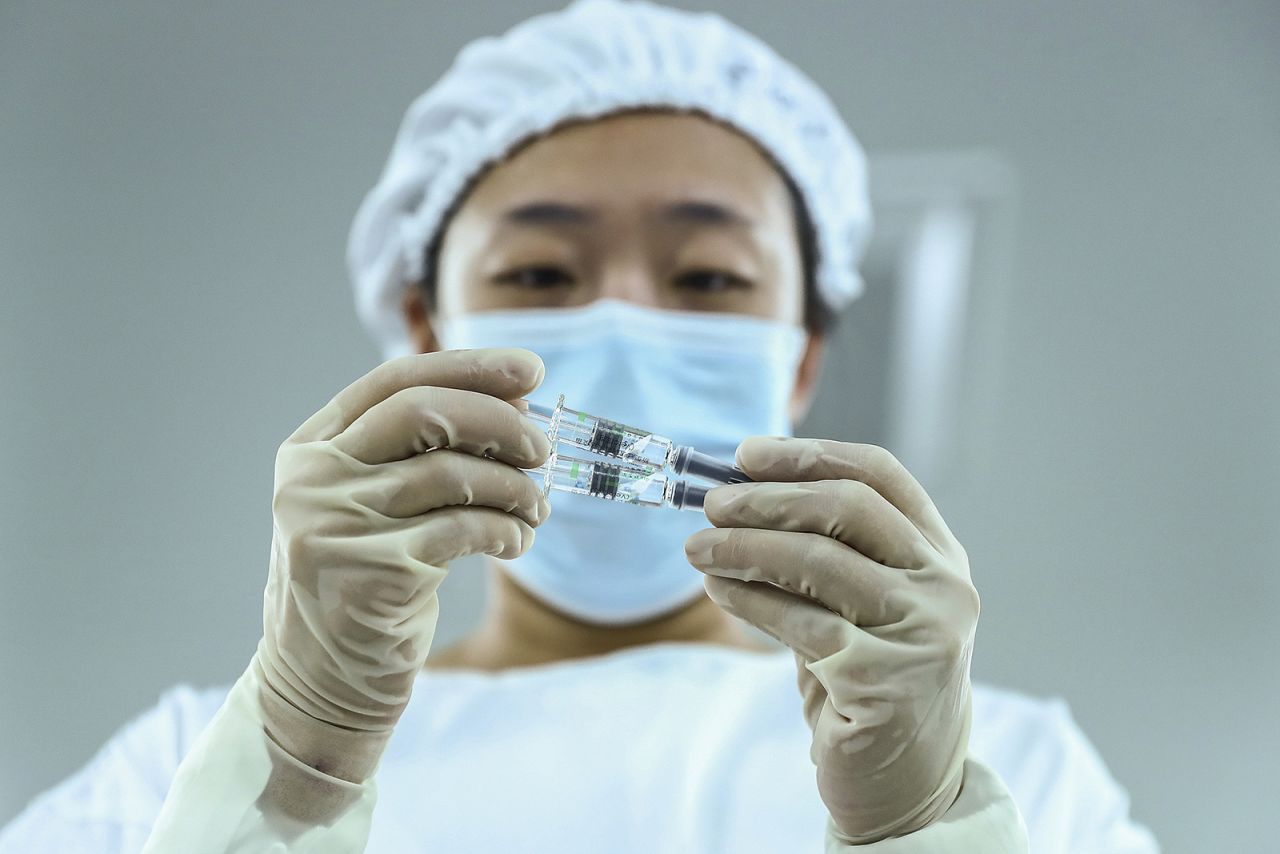 A staff member inspects syringes of Covid-19 inactivated vaccine products at a packaging plant of the Beijing Biological Products Institute Co., Ltd, a unit of state-owned Sinopharm, in Beijing. 