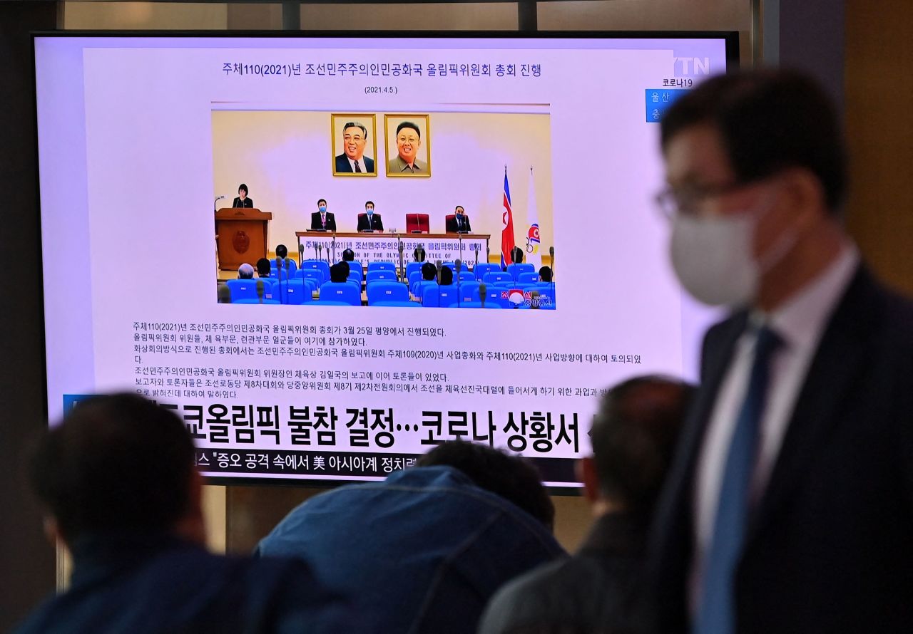 People at a railway station in Seoul, South Korea, watch a news report about North Korea's decision not to participate in the Tokyo Olympic Games due to Covid-19 concerns on April 6.