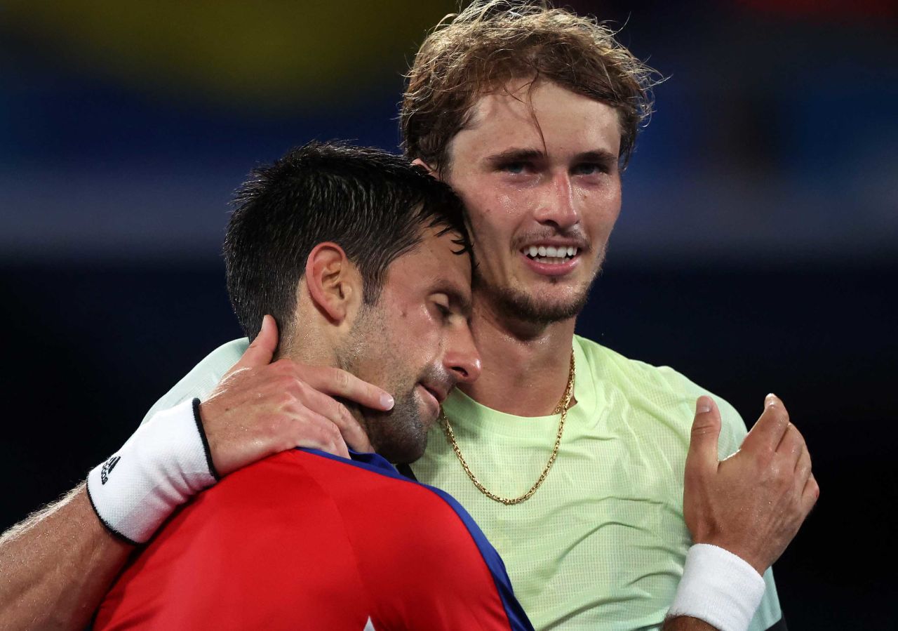 Novak Djokovic, left, and Alexander Zverev embrace after the match on July 30.