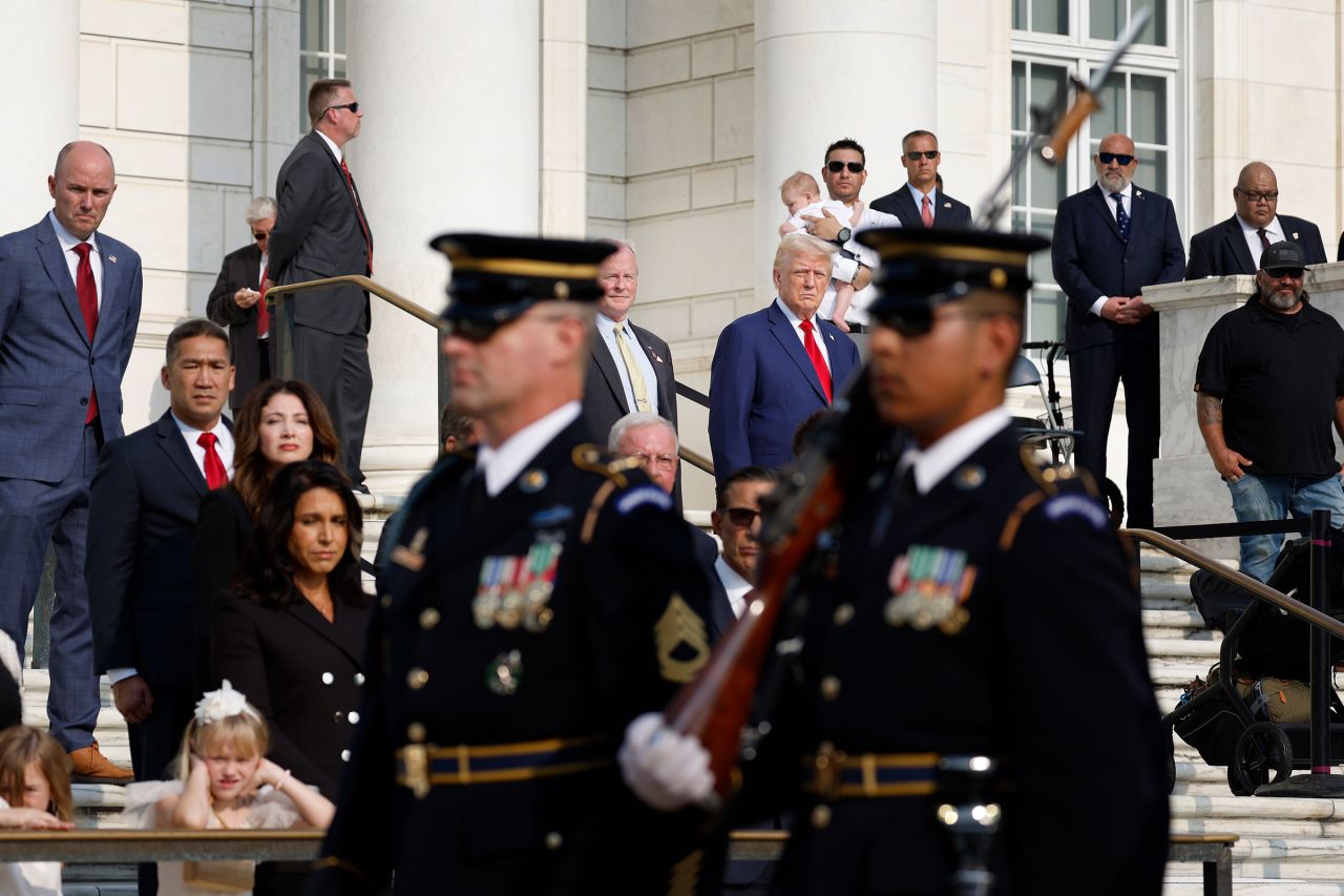 Former President Donald Trump observes a changing of the guard at the Tomb of the Unknown Soldier alongside Arlington National Cemetery Deputy Chief of Staff Bob Quackenbush at Arlington National Cemetery on August 26, in Arlington, Virginia