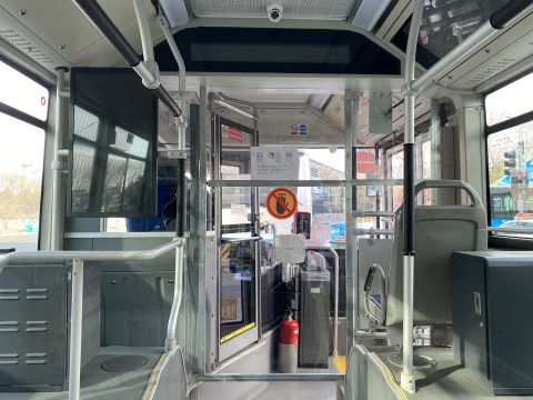 A thick partition separates the bus driver from the passengers inside the Olympic closed loop.