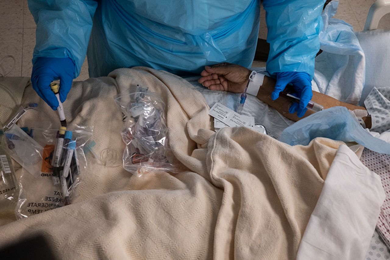 A medical staff member takes a blood sample from a patient in the COVID-19 intensive care unit (ICU) at the United Memorial Medical Center on November 26, 2020 in Houston, Texas. 