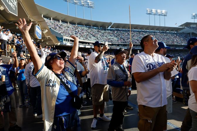 Fans sing along with the Mariachi band playing during a tribute to <a href="https://www.cnn.com/2024/10/23/sport/mlb-los-angeles-dodgers-fernando-valenzuela-death-spt-intl/index.html">Fernando Valenzuela</a> before the game. Valenzuela, the legendary pitcher whose incredible rise to stardom with the Los Angeles <a href="https://www.cnn.com/2024/10/20/sport/los-angeles-dodgers-world-series-spt-intl/index.html">Dodgers</a> captivated baseball fans and created the cultural phenomenon known as “Fernandomania,” died on Tuesday, October 22, at 63.