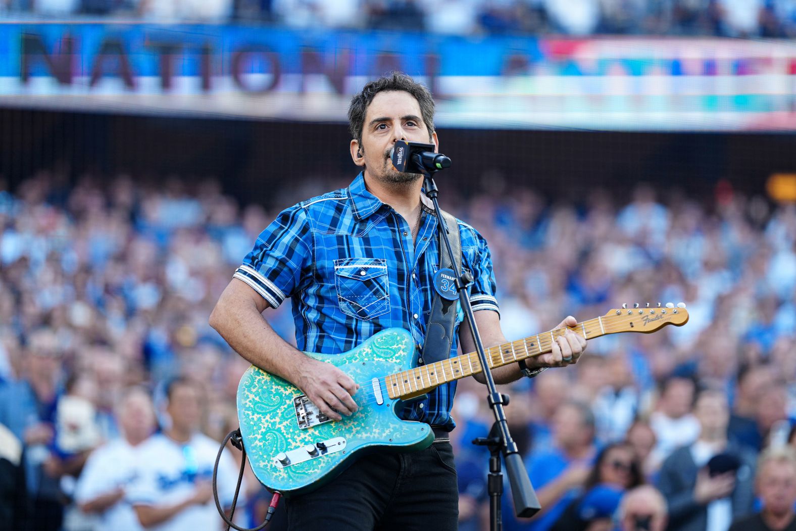 Country artist Brad Paisley sings the National Anthem before Game 1.