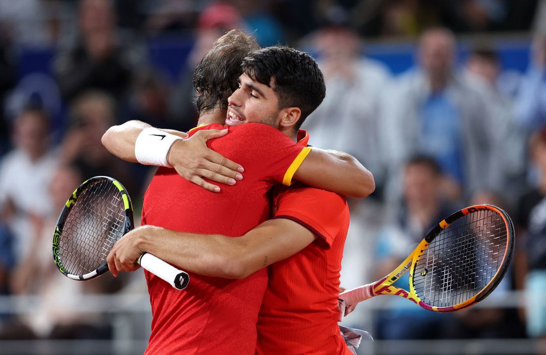 Nadal (left) and his partner Alcaraz embrace during the match.