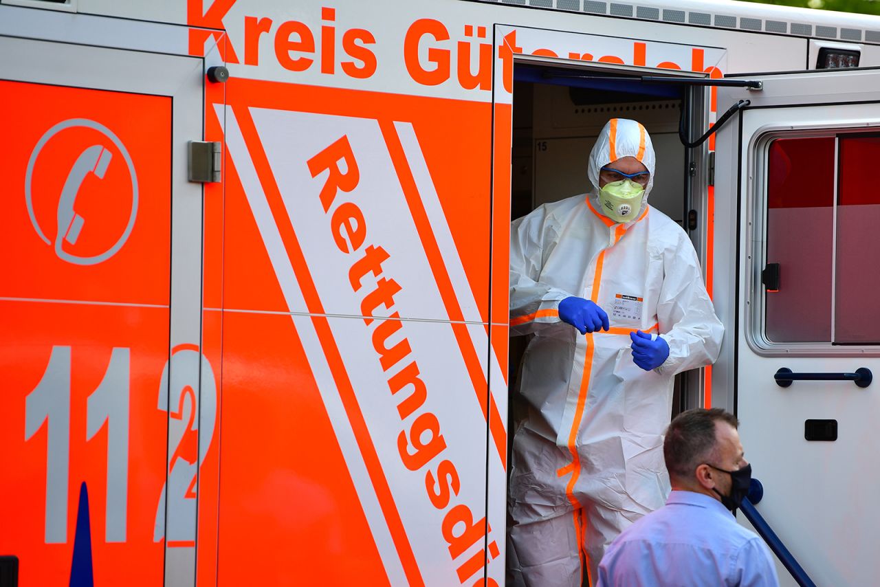 A paramedic wearing full body protection stands inside an ambulance on June 20, in Verl, near Guetersloh, Germany.