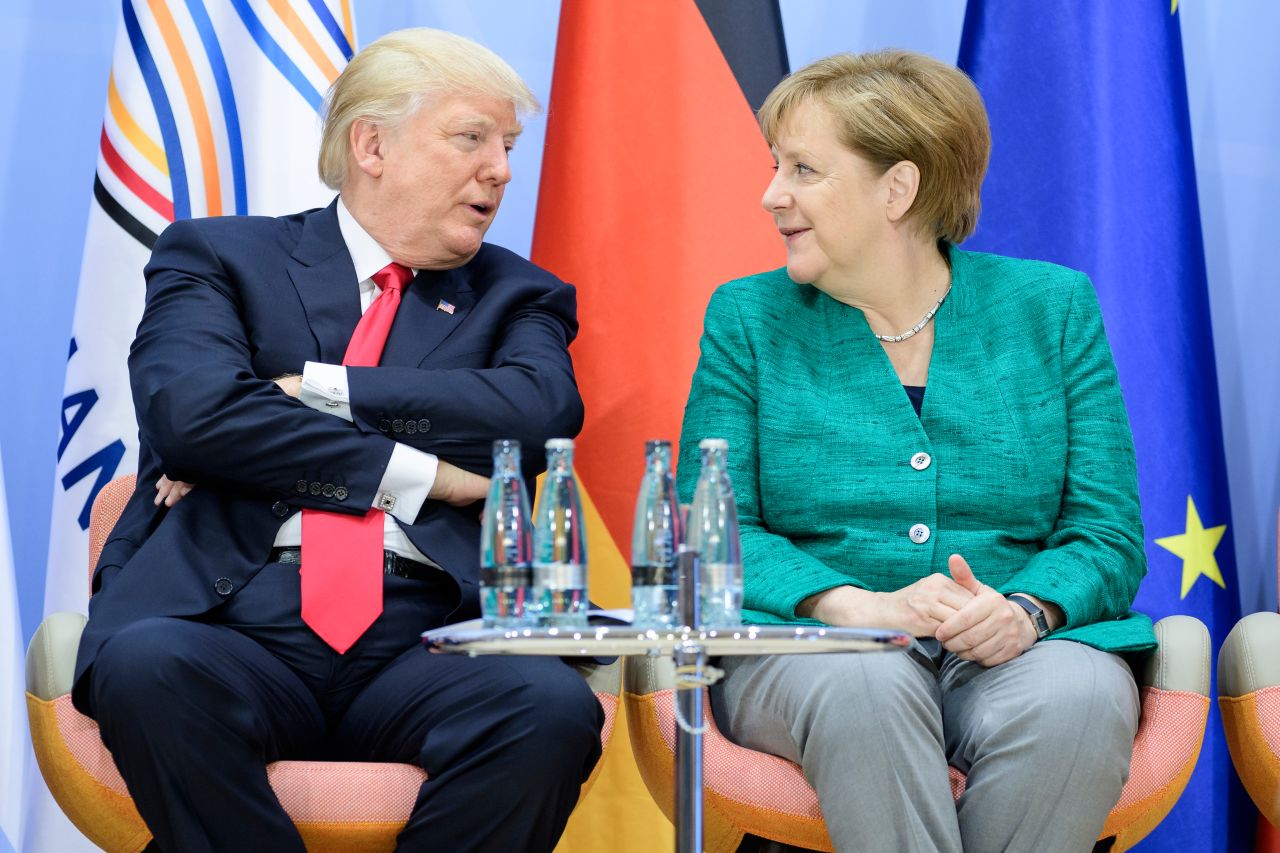 Trump and German Chancellor Angela Merkel attend a panel discussion at the G20 summit in July 