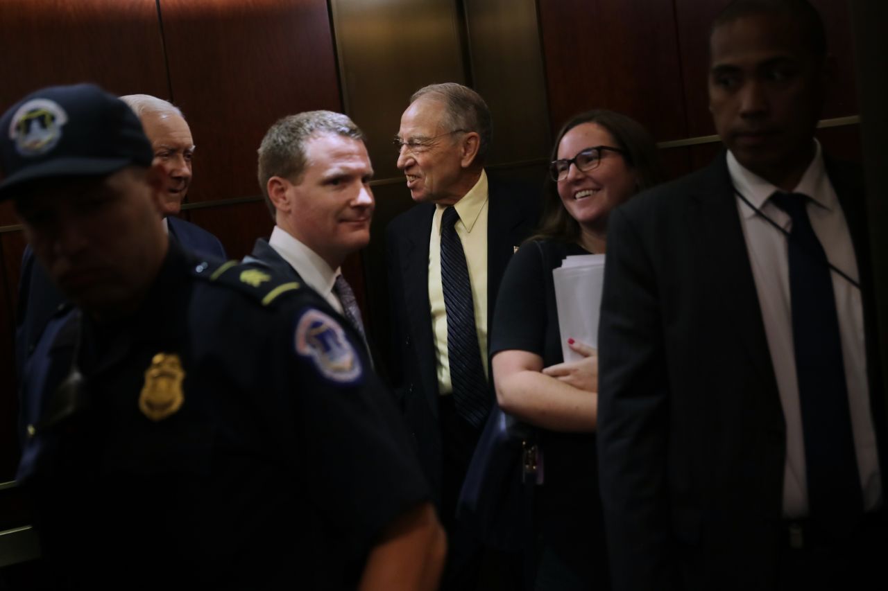 Senate Judiciary Committee Chairman Chuck Grassley smiles as he heads for a secure meeting space inside the U.S. Capitol Visitors Center so to review Brett Kavanaugh's FBI report.