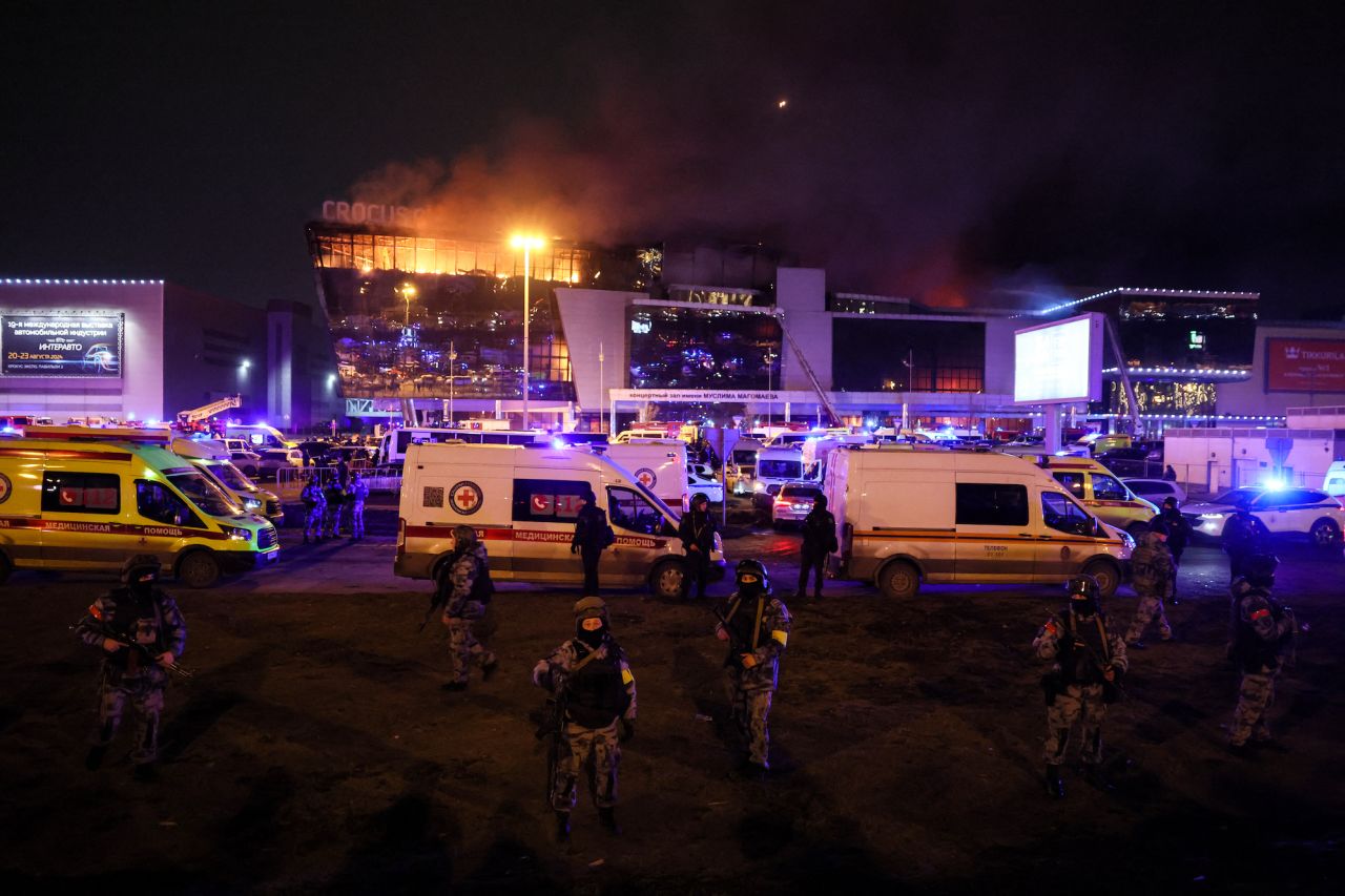 aw enforcement officers are seen deployed outside the burning Crocus City Hall concert hall in Krasnogorsk, outside Moscow, on Friday.