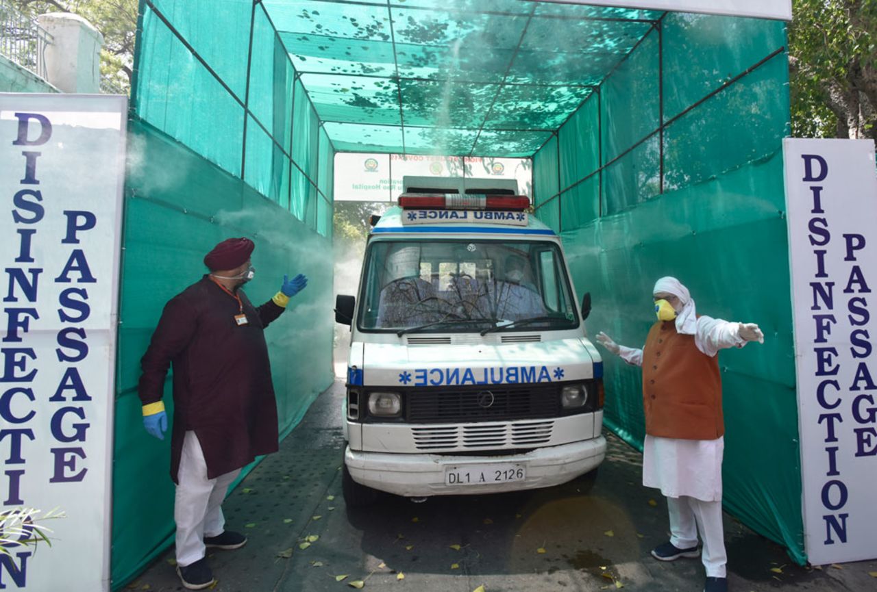 An ambulance passes through a disinfecting tunnel at the Hindu Rao Hospital in New Dehli on April 12.