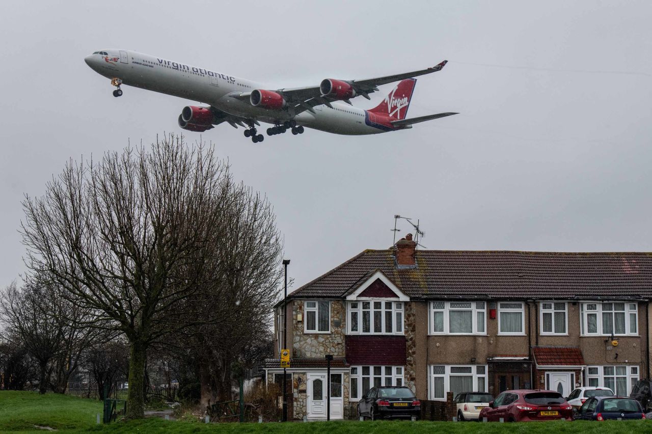 A plane comes in to land at Heathrow airport over nearby houses on February 27.