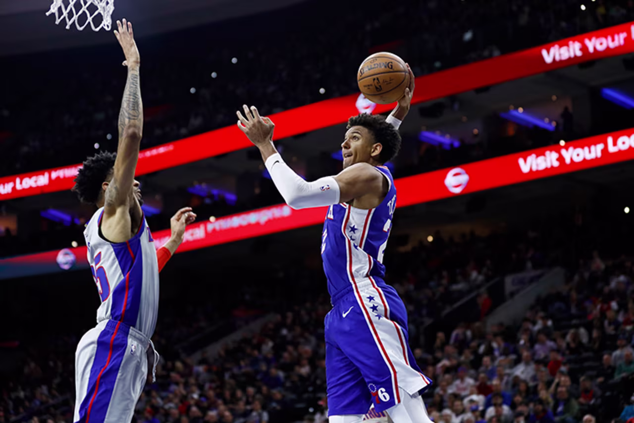 Philadelphia 76ers' Matisse Thybulle, right, goes up for a dunk against Detroit Pistons' Christian Wood during the second half of an NBA basketball game, Wednesday, March 11, in Philadelphia.
