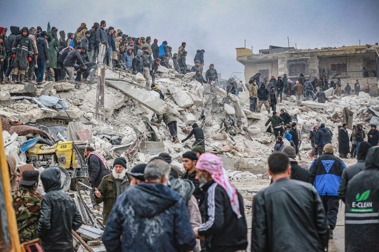 Rescue personnel and civilians conduct search and rescue operations in Idlib, Syria, on February 6.