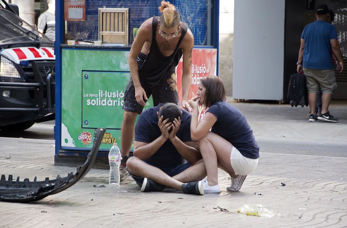 Personas heridas reaccionan después de que una camioneta se estrellara contra peatones en la sección de Las Ramblas del centro de Barcelona, ​​España.