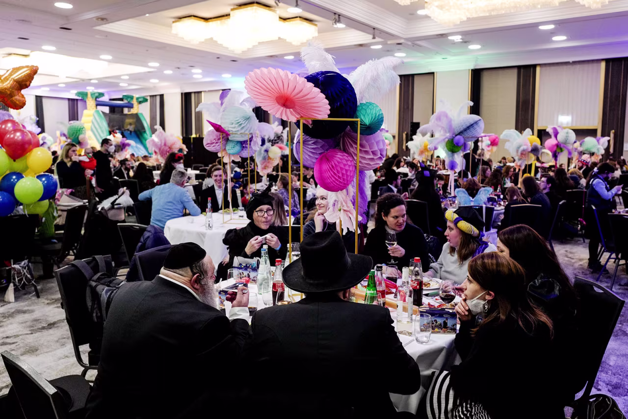 Members of the Berlin Jewish community celebrate together with refugees from Odessa, Ukraine, during Purim in Berlin, Germany on Thursday.