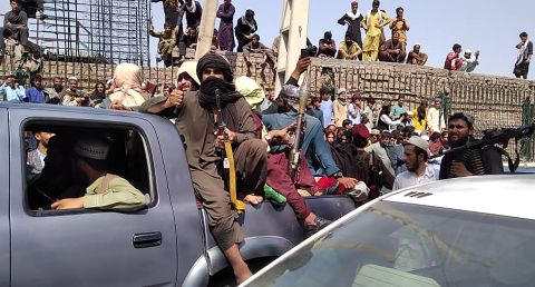 Taliban fighters sit on a vehicle along the street in Jalalabad province, Afghanistan on August 15.