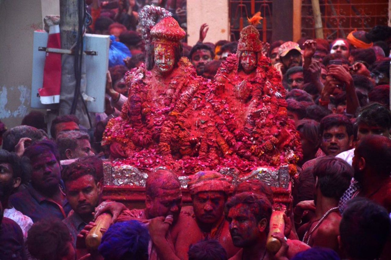 Hindu devotees smeared in colored powder carry the images of Lord Shiva, left, and Goddess Parvati from the Kashi Vishwanath temple during Holi, the spring festival of colours, in Varanasi on March 5.