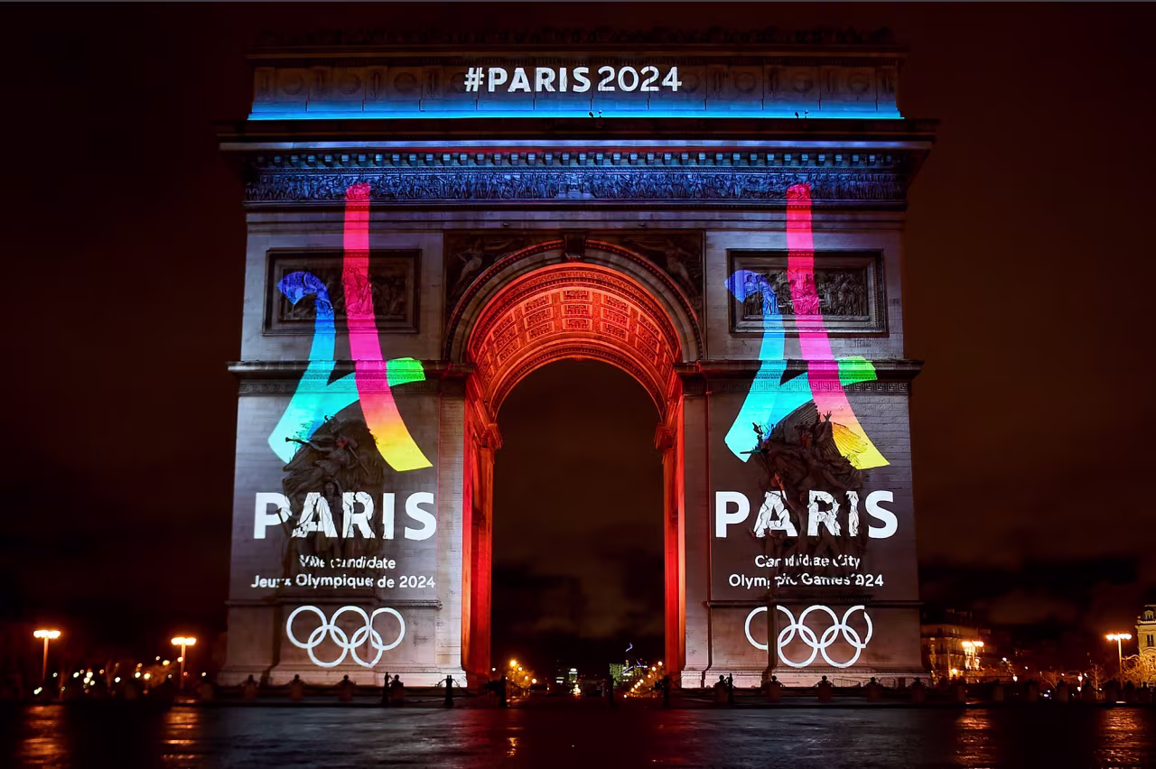 A logo for the 2024 Olympic Games is displayed on the Arc de Triomphe in Paris. 