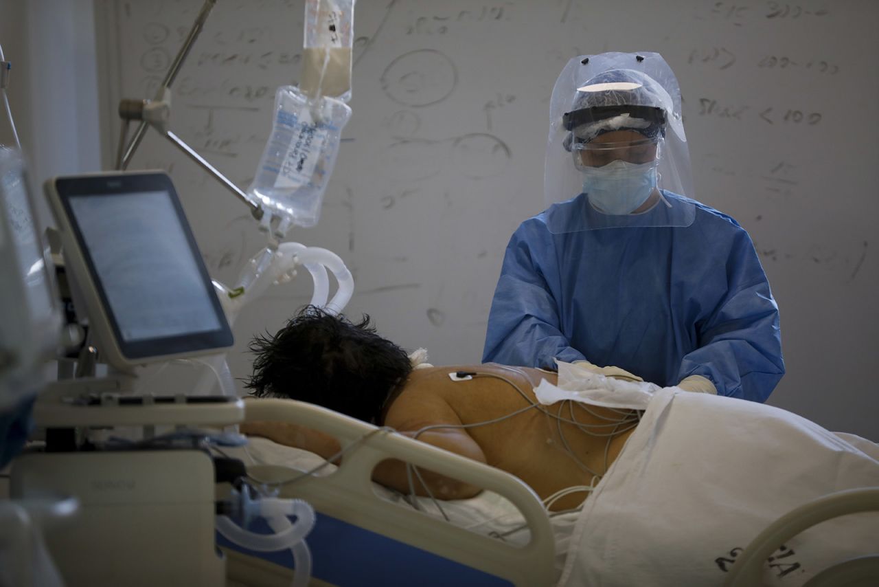 A health worker attends a Covid-19 patient in the intensive care unit (ICU) at a hospital in Buenos Aires, Argentina, on Tuesday, Aug. 18.