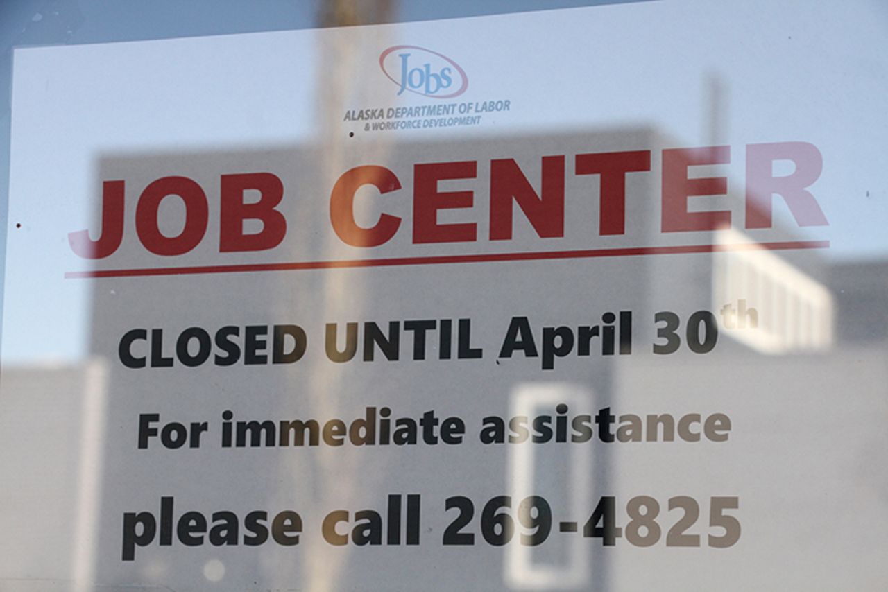 A sign saying that the Jobs Center at the Alaska Department of Labor and Workforce Development office in midtown Anchorage, Alaska, is closed through the end of April is shown Monday, March 30. 