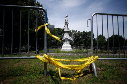 A statue of Christopher Columbus is seen behind barricades at Marconi Plaza, on Monday, June 15, in Philadelphia.