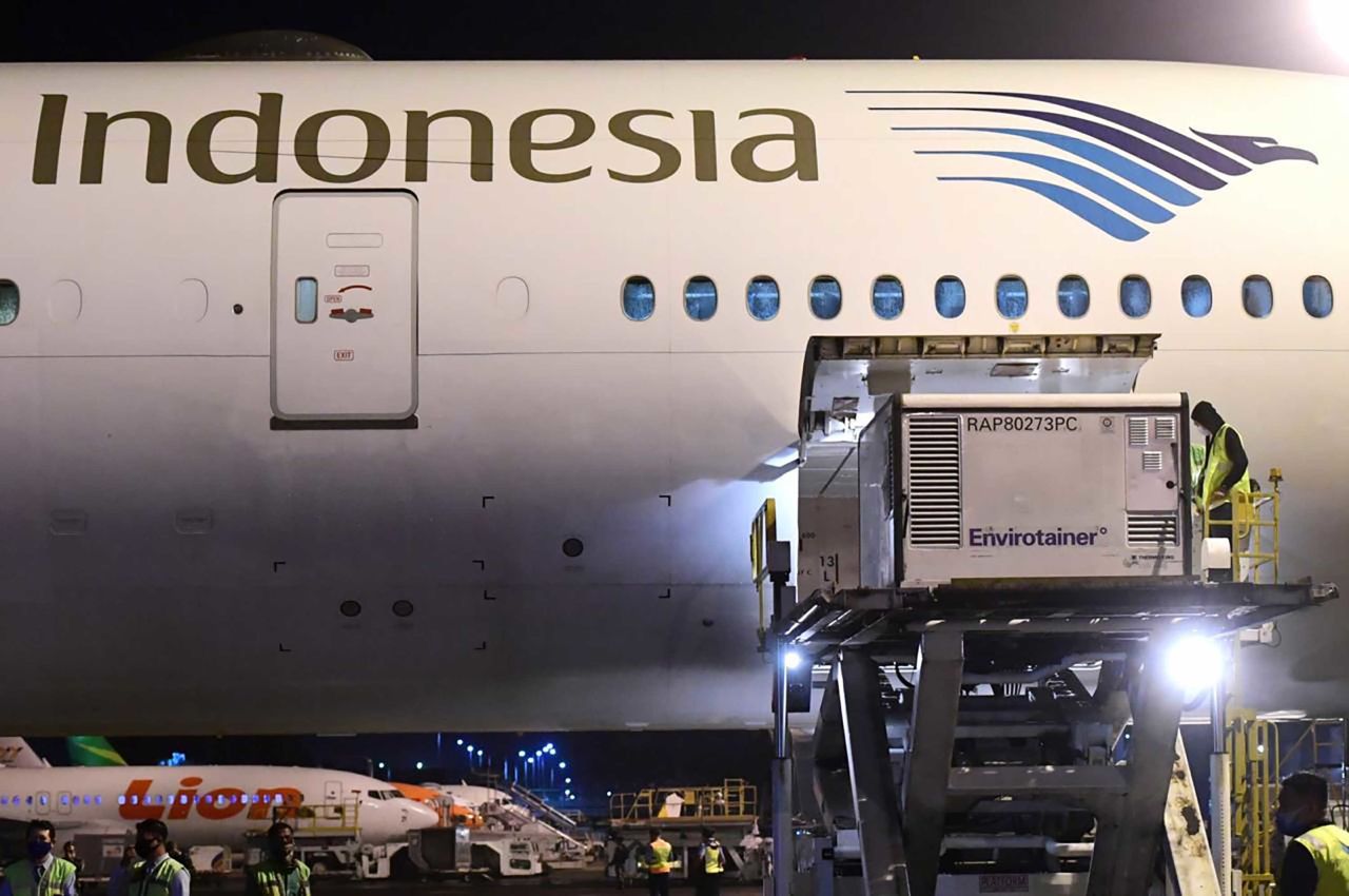 Workers unload a shipment of the Covid-19 vaccine made by Sinovac, upon its arrival from Beijing at the Jakarta International Airport in Indonesia on December 6.