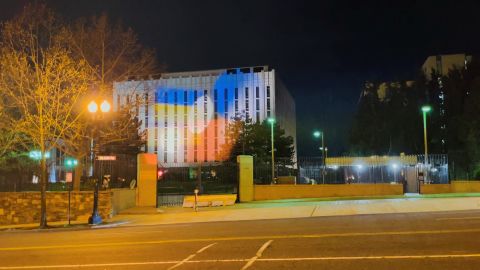 A white spotlight is cast over Ukrainian flags projected onto the exterior of the Russian Embassy in Washington DC on April 14.