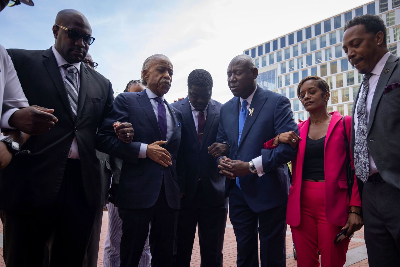 Rev. Al Sharpton and attorney Ben Crump hold a prayer with members of George Floyd's family outside of the Hennepin County Government Center in Minneapolis.