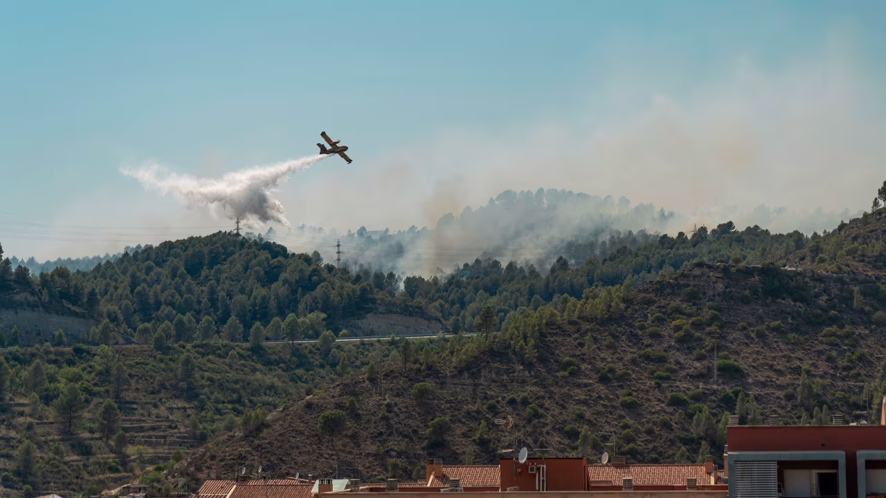 A plane drops water over fires in the Catalonia region countryside in Manresa, Spain, on July 18.