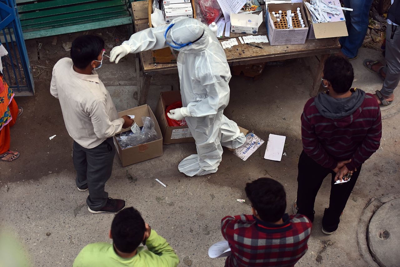 A health worker collects a swab sample from a man for Covid-19 test, at a dispensary in New Delhi, India, on December 5.