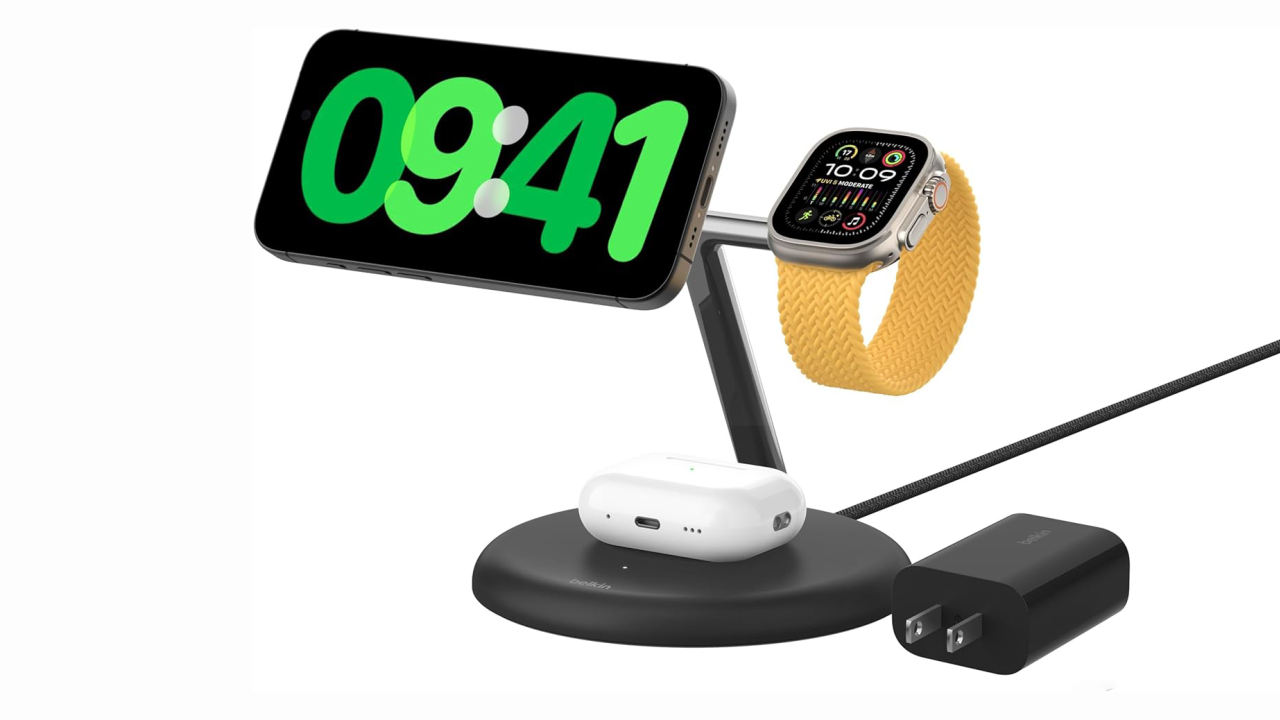 A charging stand with an iPhone in standby mode, an Apple Watch Ultra charging and an Airpods case charging too, with a power adapter next to it.