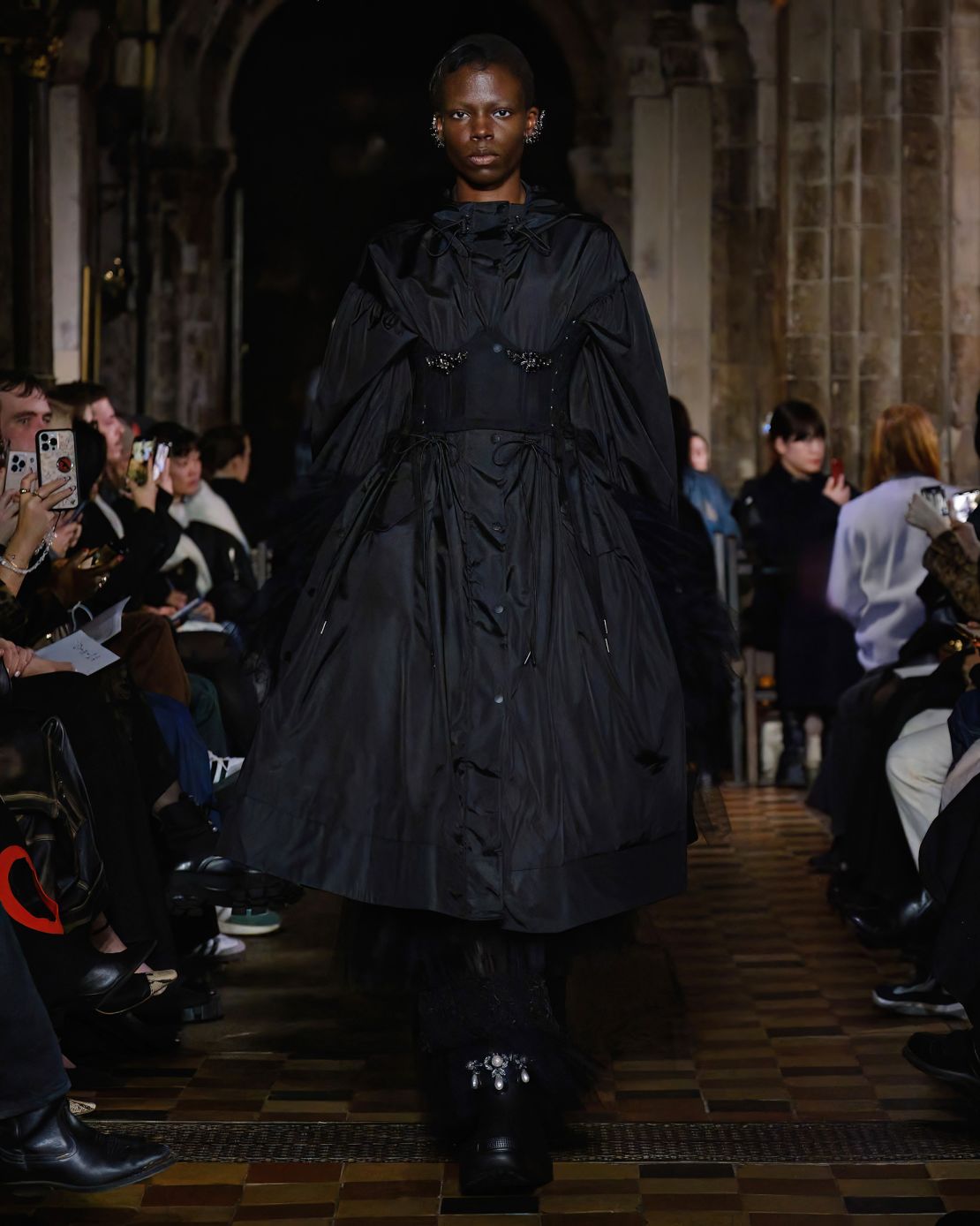 A raincoat becomes the belle of the ball at Simone Rocha.