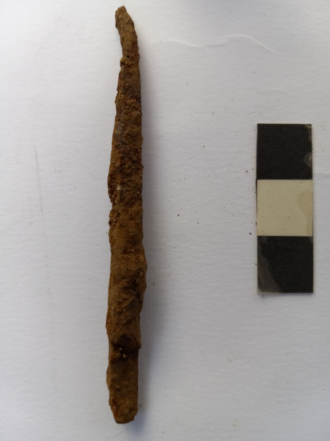 A bent javelin point found at the site