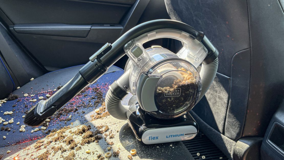 The Black+Decker Max Flex Handheld Vacuum cleaning food from car seat.