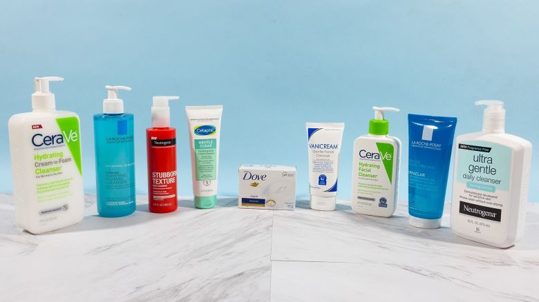 Nine drugstore face washes on display on a white countertop