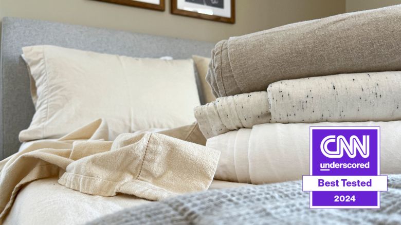 A stack of flannel sheets on a bed.