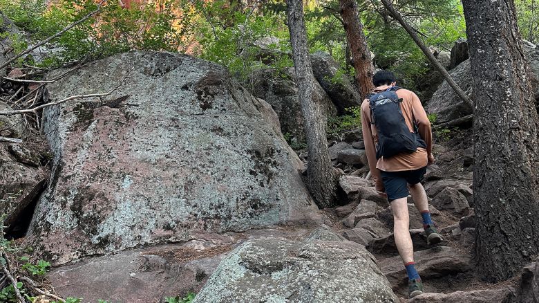 Hiker hiking on rocky trail
