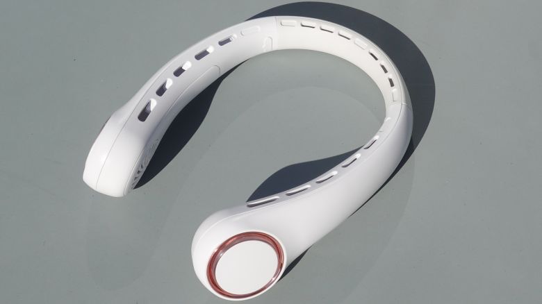 White Gulaki neck fan placed on patio table.