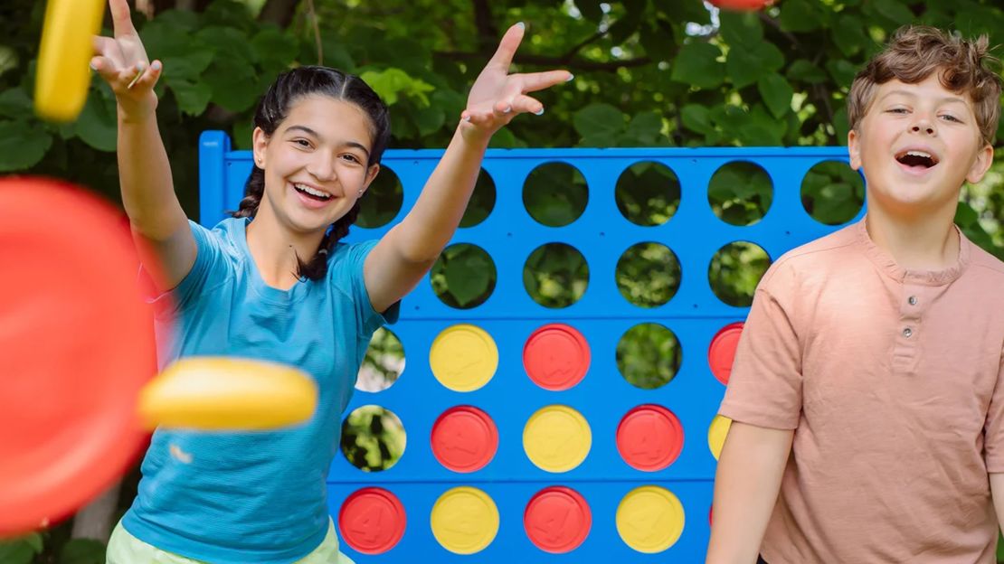 Two kids in front of Giant Connect 4 set